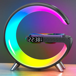 Alt Text: "Image Description: Discover the ultimate in convenience and style with the Bluetooth Speaker Wireless Charger Lamp. Available in black, light gray, white, blue, green, or pink, this lamp measures 22.5 by 8.2 by 23 centimeters, offering a blend of illumination, music, and wireless charging table and a digital clock face. The lamp is configured in a capital "G" shape that is illuminated around the inside bezel of most of the lamp face."